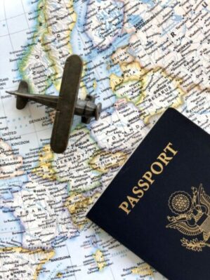 flat lay overhead of airplane passport on a map 2023 11 27 05 24 24 utc scaled e1751321536151